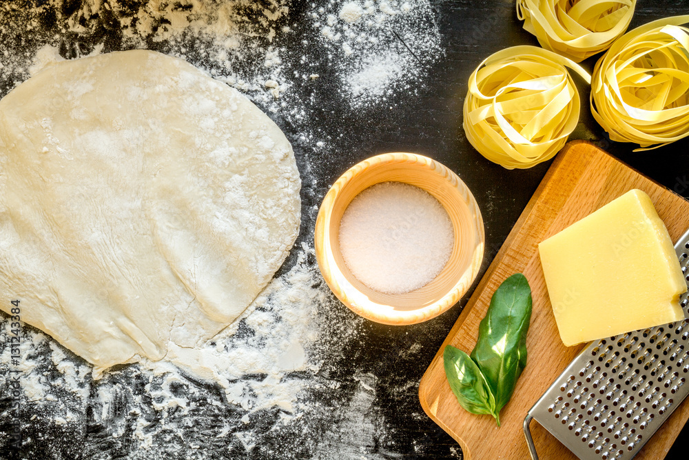 cooking process of pasta on dark background top view