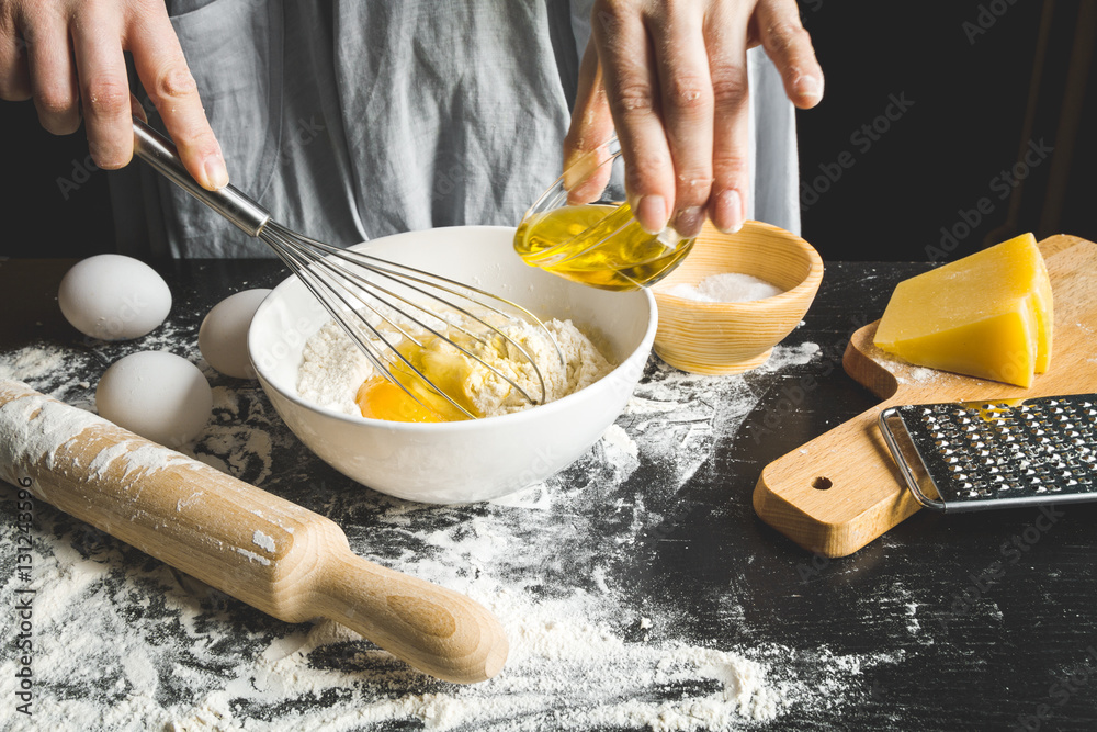 cooking pasta by chef in kitchen on dark background