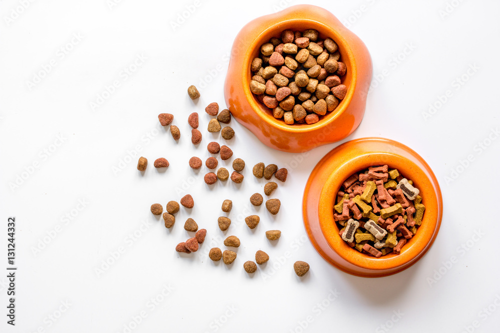 dry pet food in bowl on white background top view