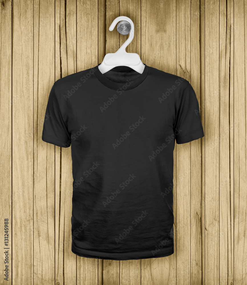 Black T-shirt hanging on a wooden wall