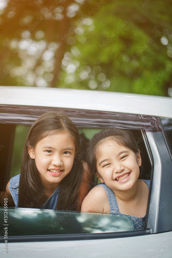 Happy Asian girl smiling on mini van window, Family traveling on summer