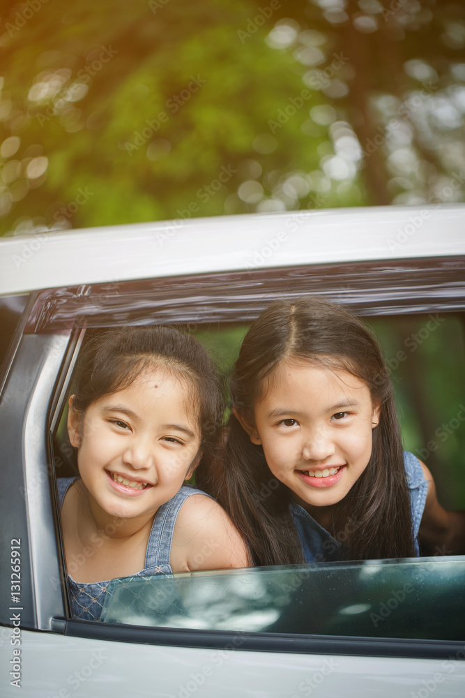 Happy Asian girl smiling on mini van window, Family traveling on summer