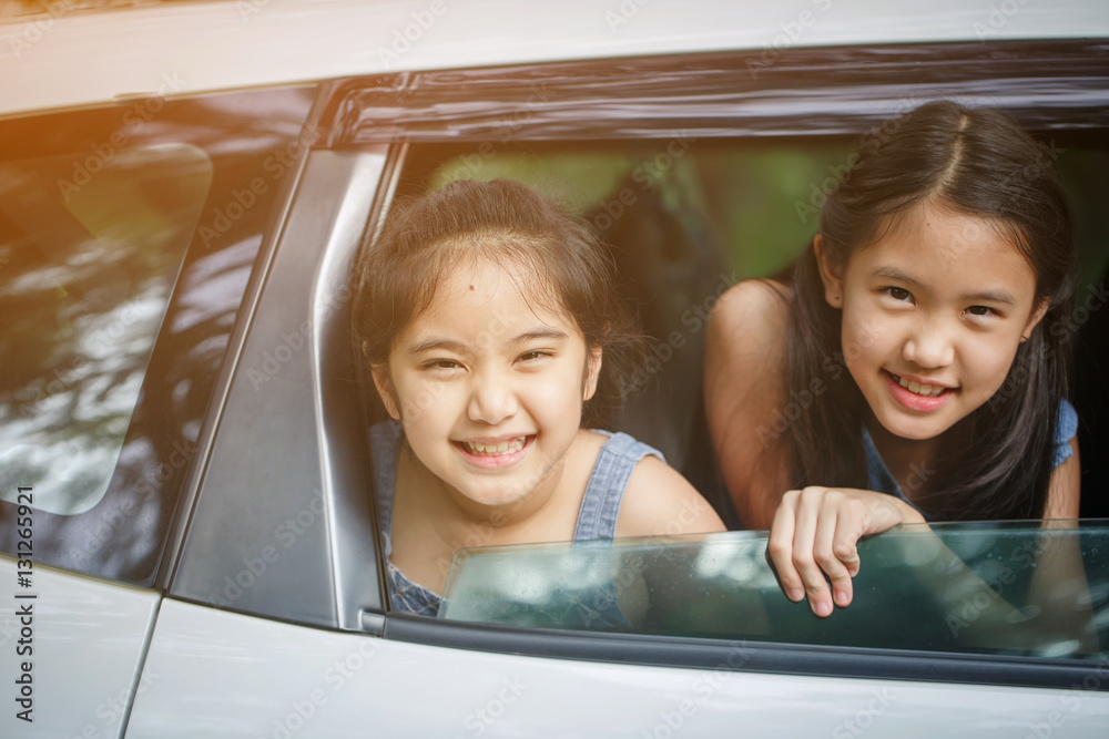 Happy Asian girl smiling on mini van window, Family traveling on summer