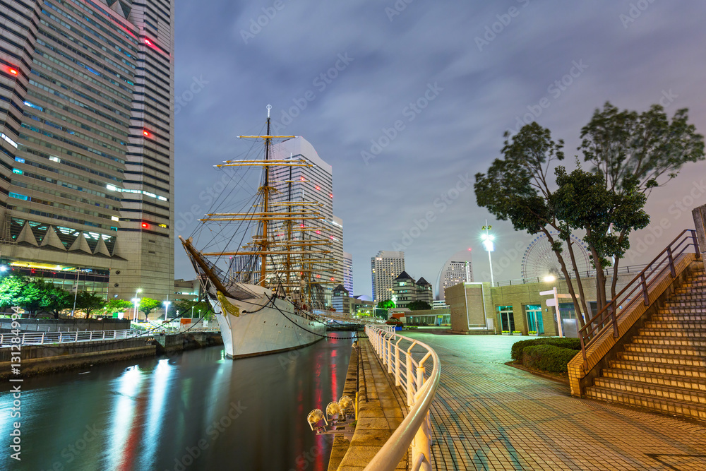 Cityscape of Yokohama with sailing ship at night, Japan