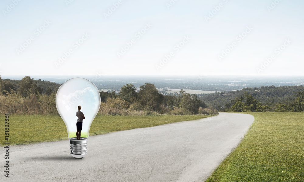 Businesswoman inside light bulb