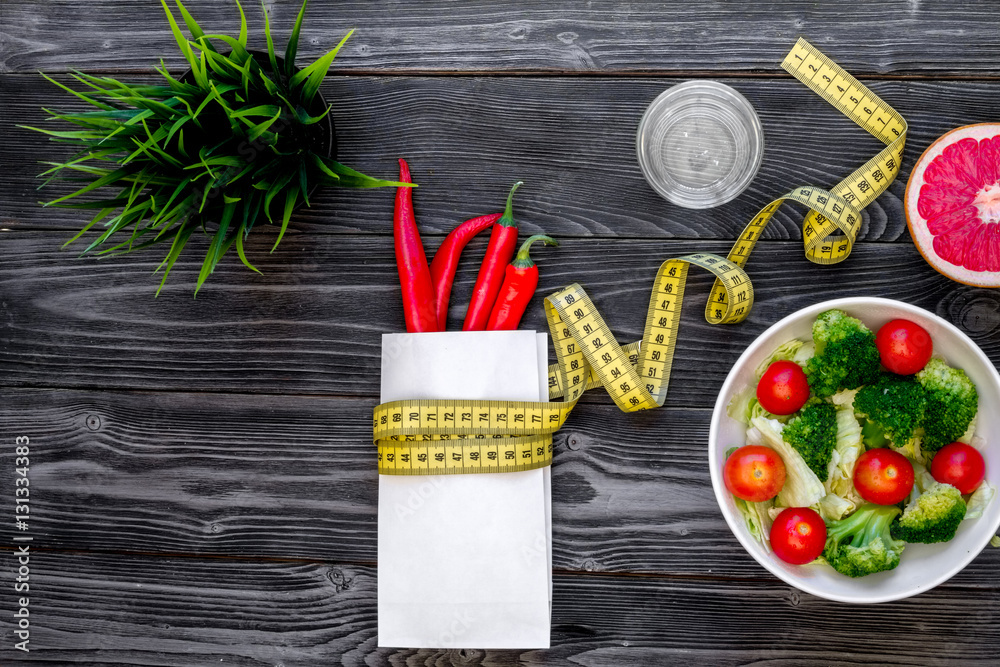 concept slimming diet fresh vegetables on wooden background top view