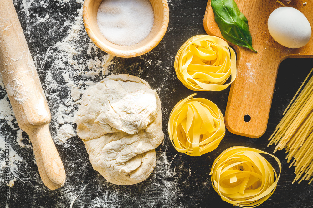 cooking process of pasta on dark background top view