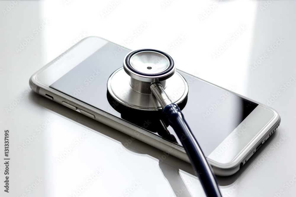 diagnostic of gadgets on white background with stethoscope