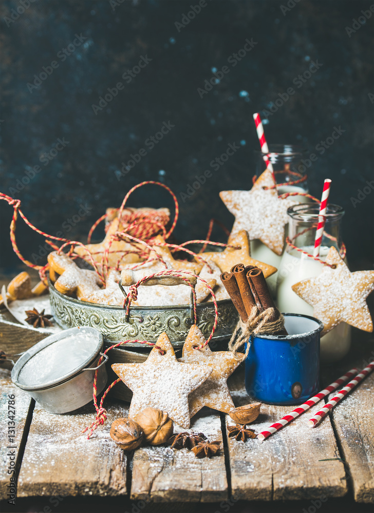 Christmas festive gingerbread cookies or biscuits in vintage tray, decoration rope, nuts, spices, mi