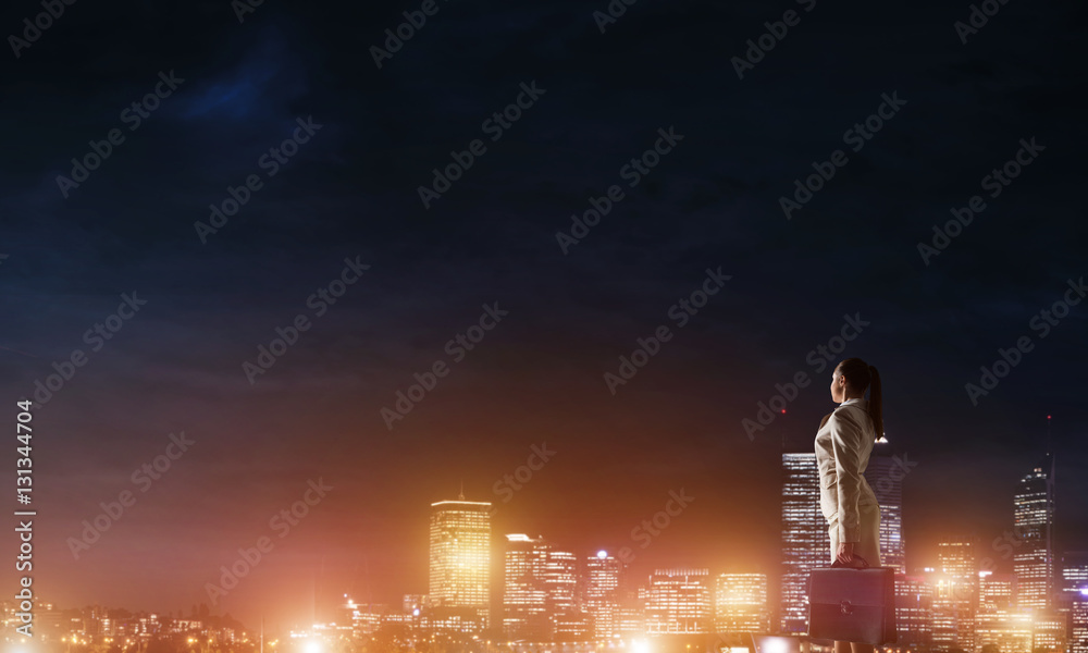 Woman looking at night city