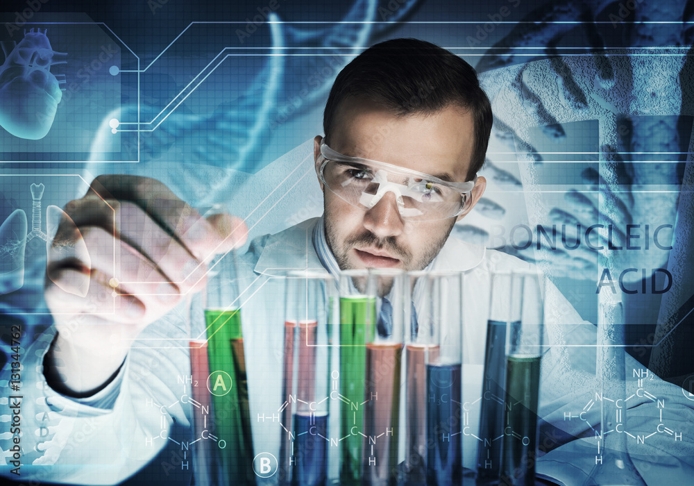 Portrait of concentrated male scientist working with reagents in laboratory