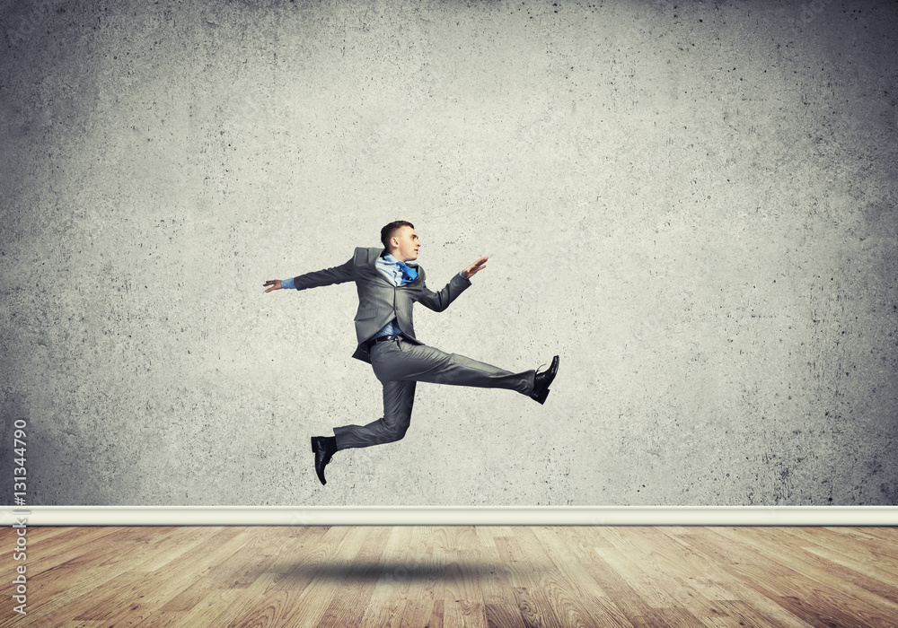 Businessman jumping high