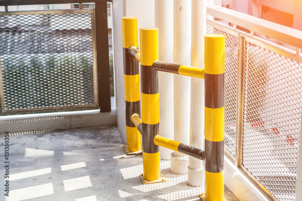 yelow column for protect water system tube in parking lot in bui