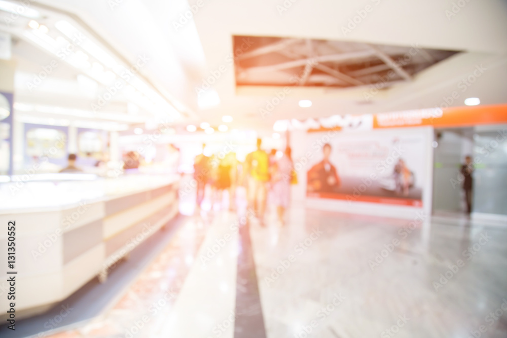 blurred image of shopping mall and people .