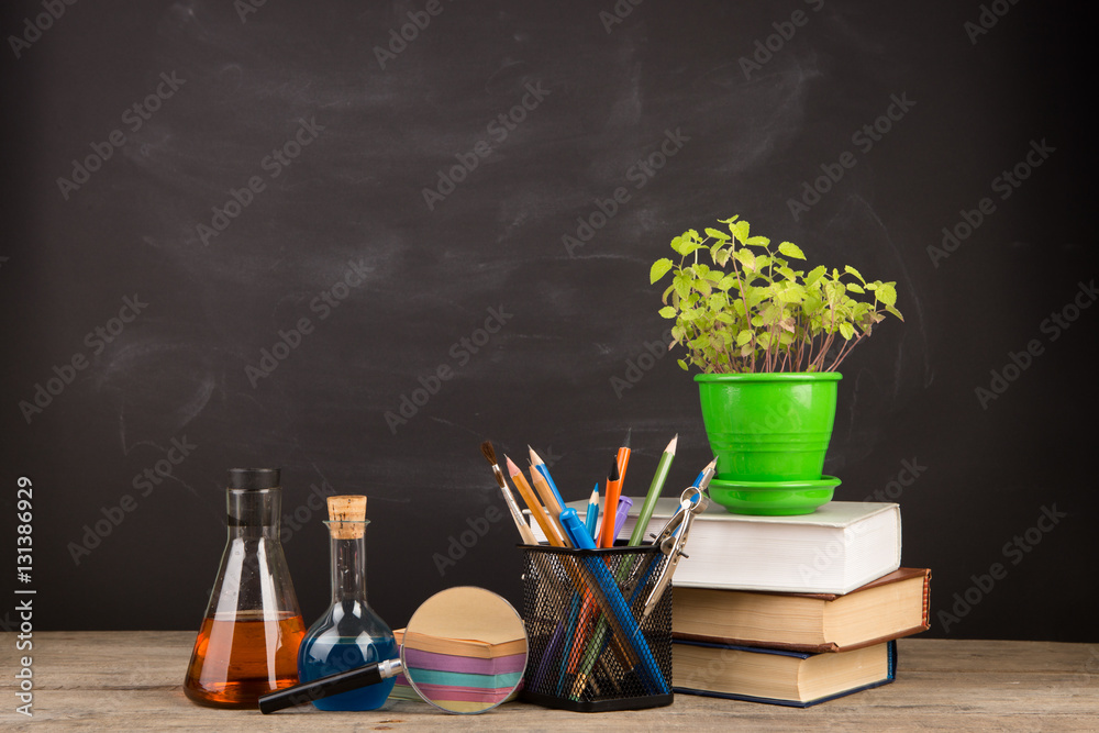 Education concept - books on the desk in the auditorium