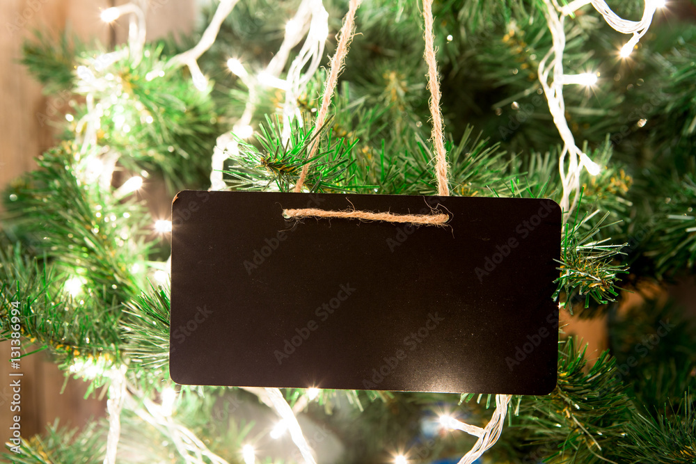 Christmas tree with lights on the wooden background