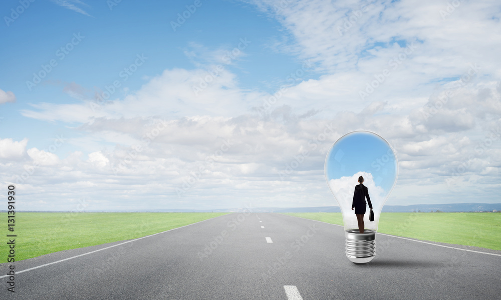 Businesswoman inside light bulb