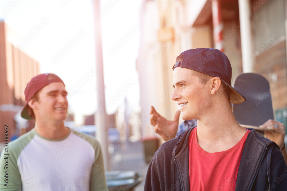 Guys skateboarders in street