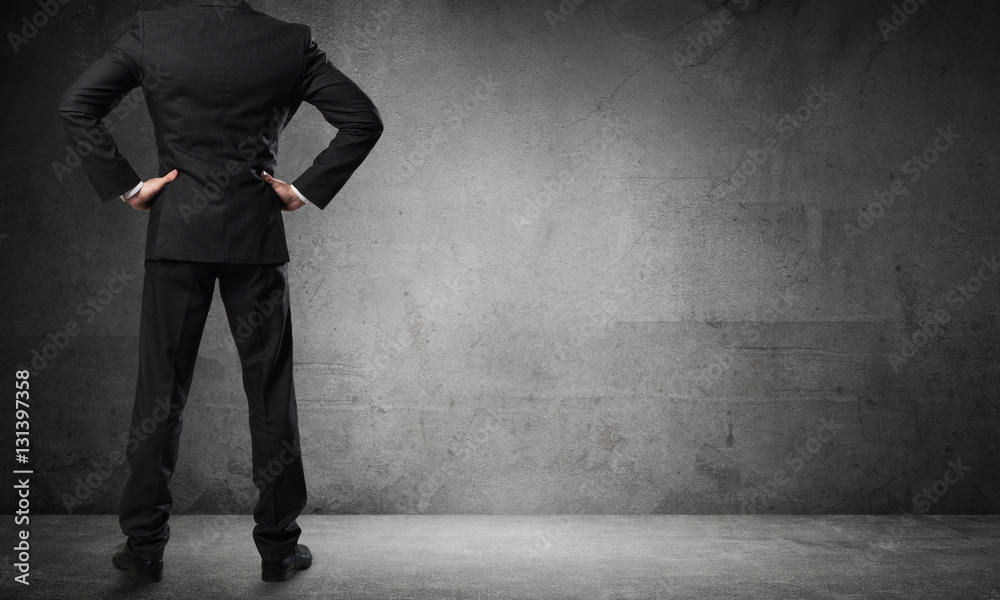 Businessman looking at wall