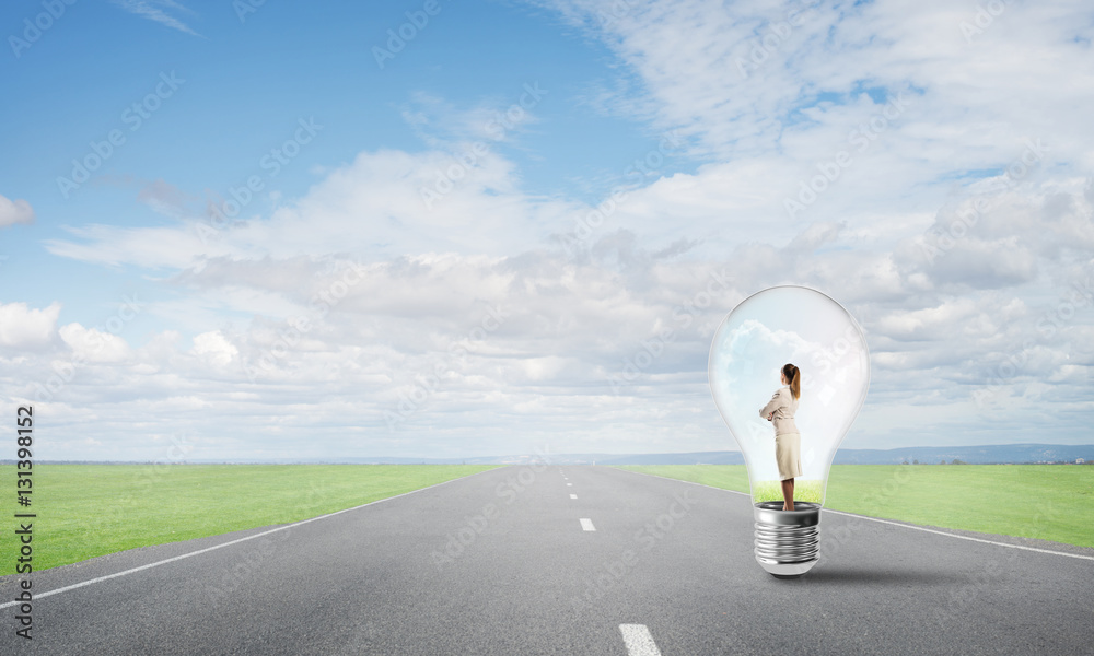 Businesswoman inside light bulb