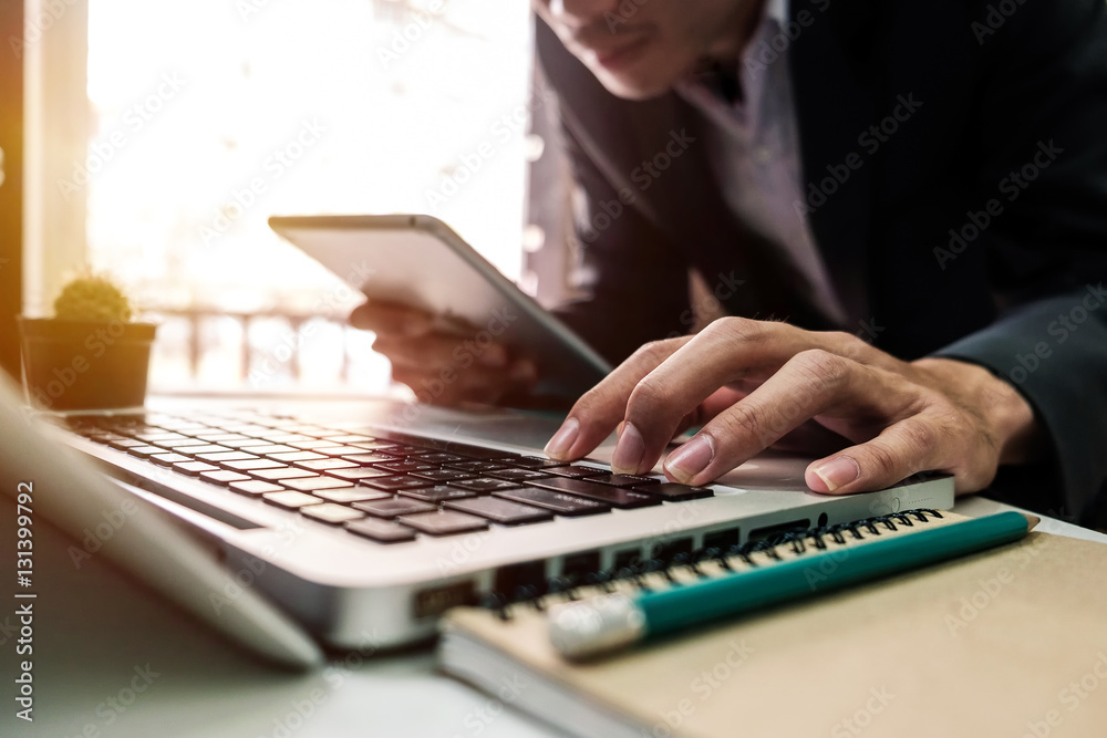 business documents on office desk with laptop and digital tablet and graph business diagram and man 