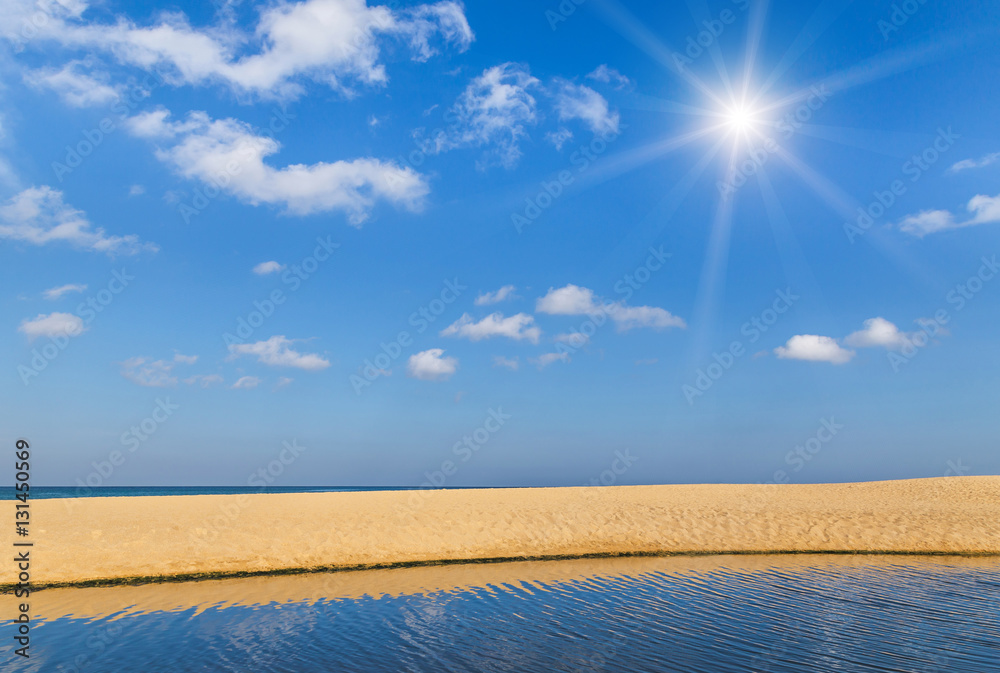 empty tropical beach in andaman sea on  blue sky background with sunlight