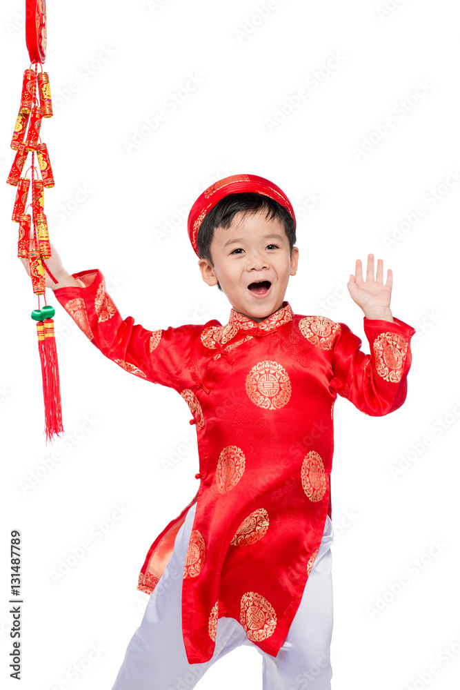 Portrait of a funny and exciting Vietnamese boy with firecracker