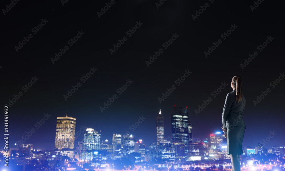 Woman looking at night city