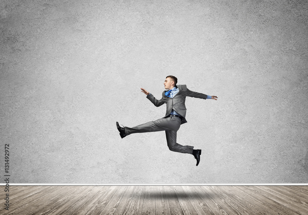 Businessman jumping high