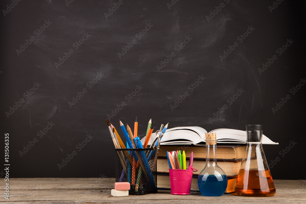 Education concept - books on the desk in the auditorium