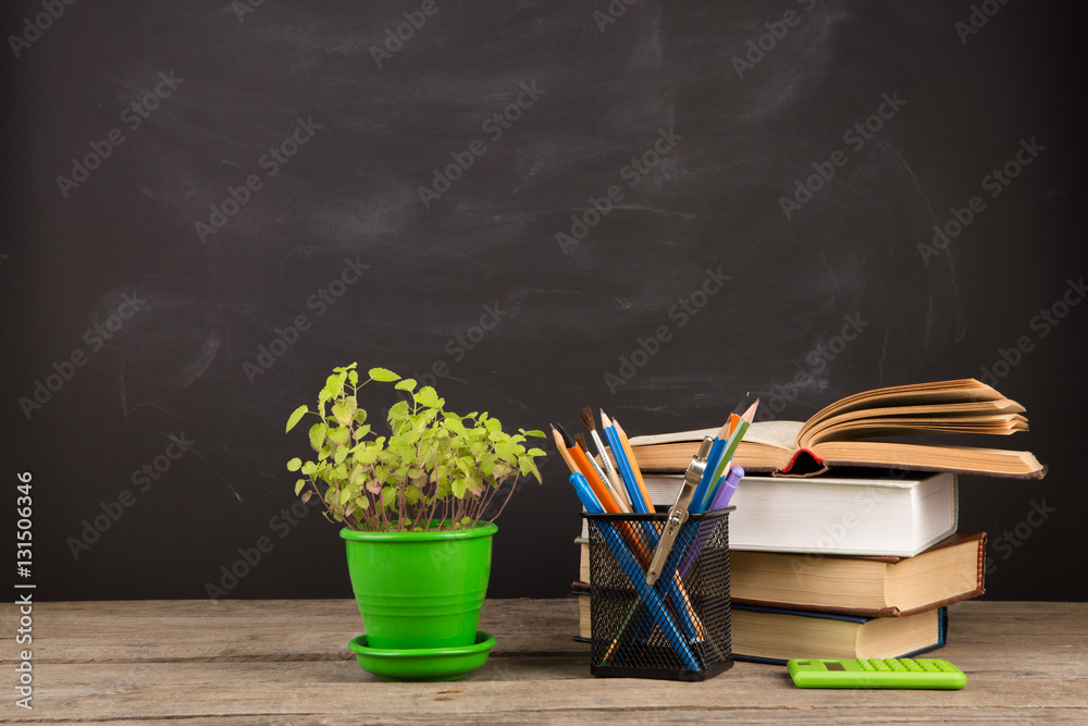 Education concept - books on the desk in the auditorium