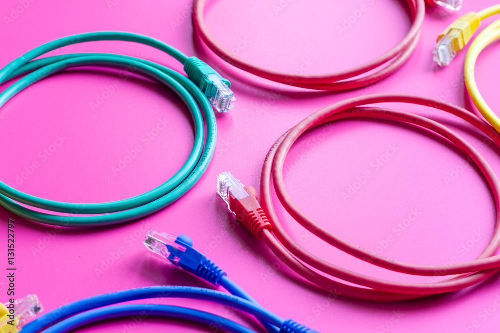 concept network internet cable on pink background close up