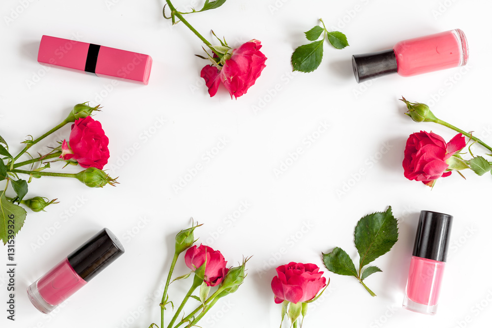 berry color decorative cosmetics with roses white background top view