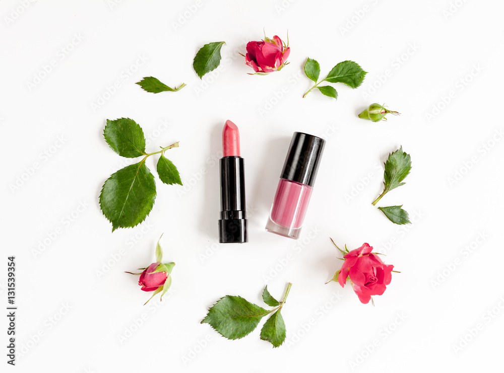 berry color decorative cosmetics with roses white background top view