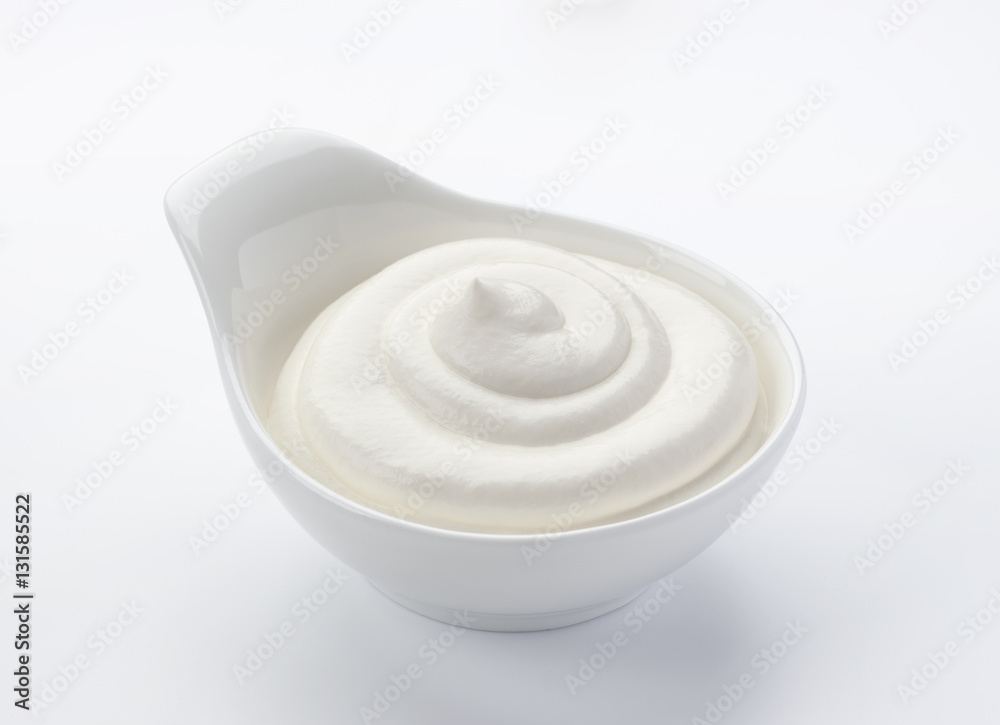 Isolated sour cream in bowl on white background