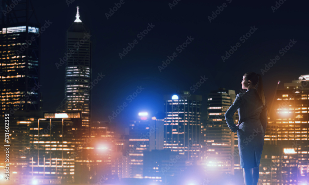 Woman looking at night city