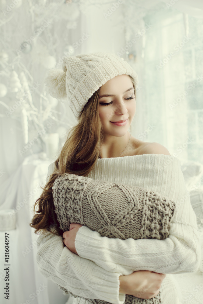 Indoor waist up portrait of young beautiful happy smiling girl holding pillow and closed her eyes. M