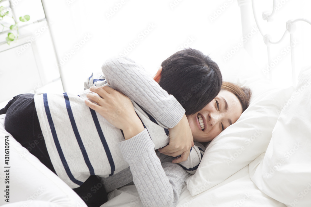 My mother and son are lying on the bed