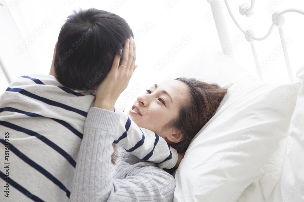 My mother and son are lying on the bed