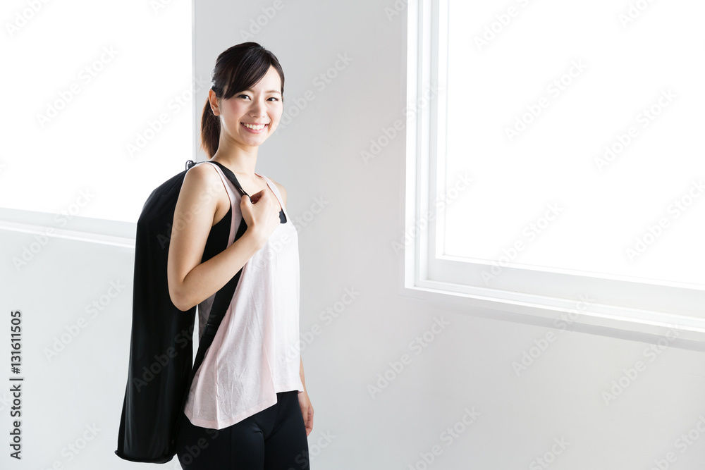 young asian woman relaxing in sports gym