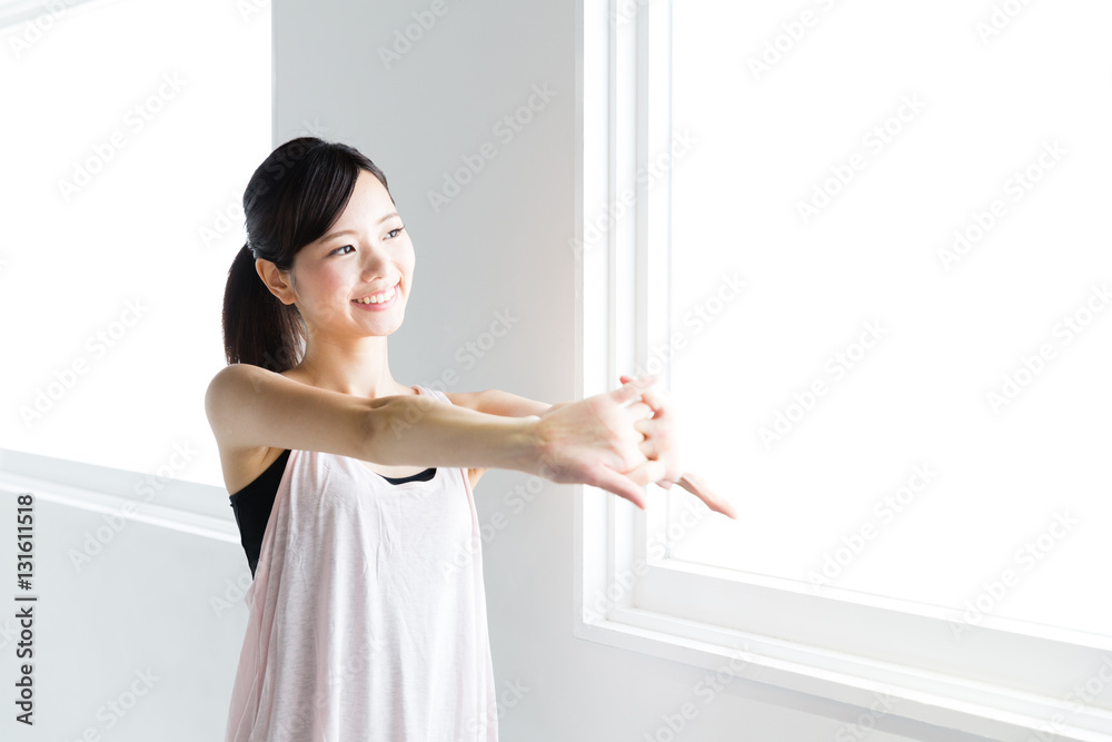 young asian woman relaxing in sports gym