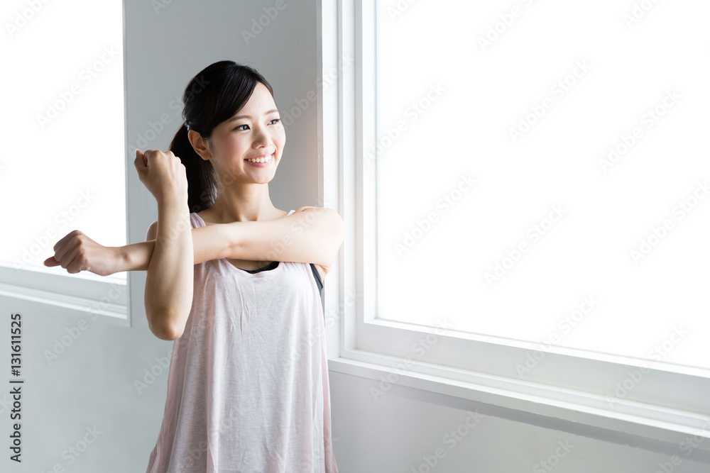 young asian woman relaxing in sports gym