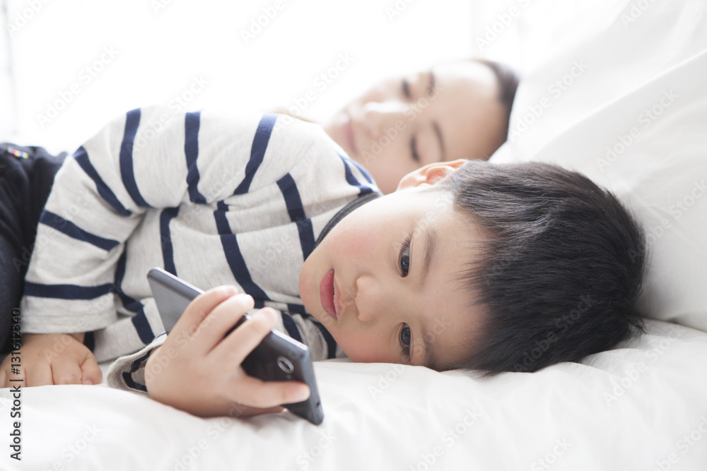 My mother sleeps and my son is watching smartphone