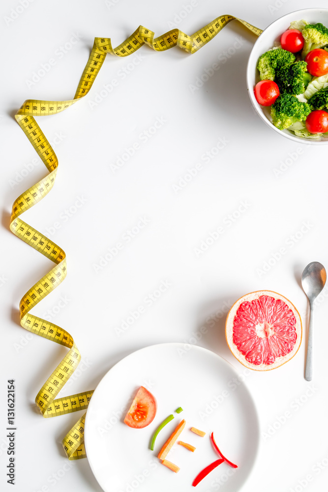 concept slimming diet fresh vegetables on white background top view