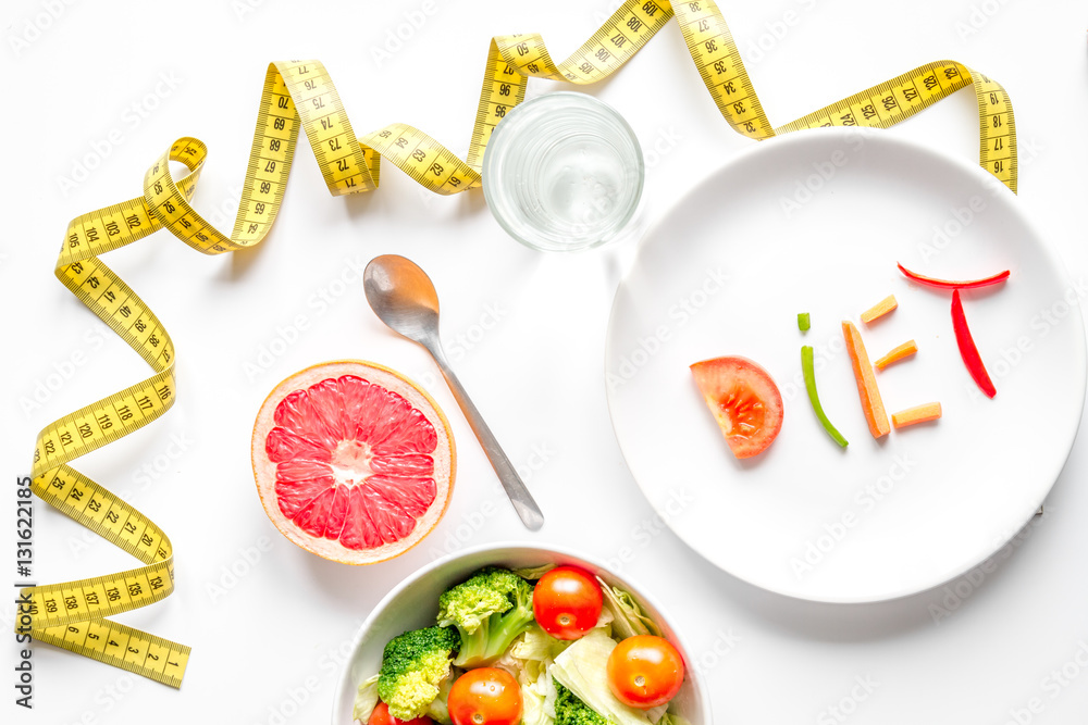 concept slimming diet fresh vegetables on white background top view