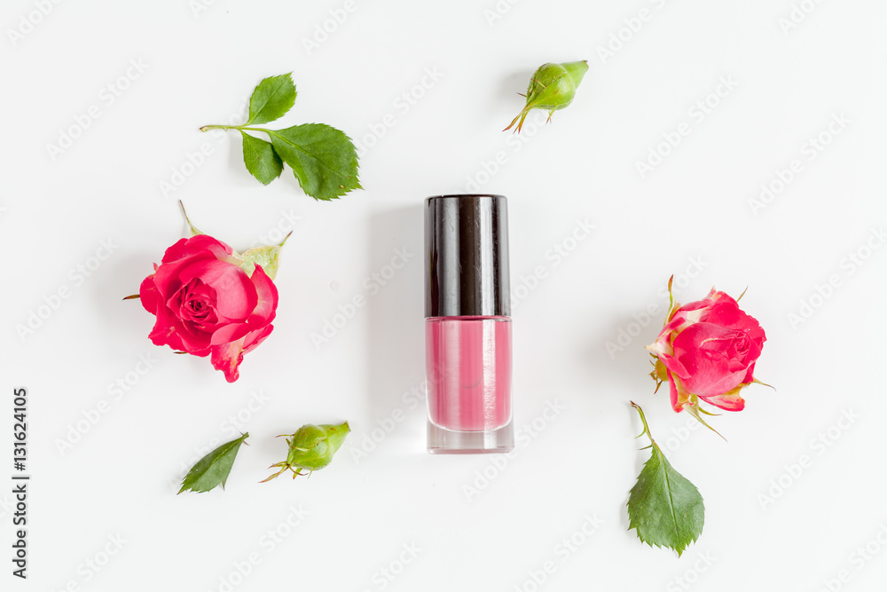 berry color decorative cosmetics with roses white background top view