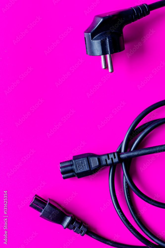 wires for charging on pink background top view