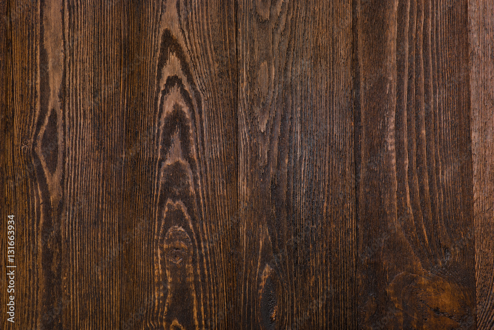 Dark brown wooden background. Texture. Top view.