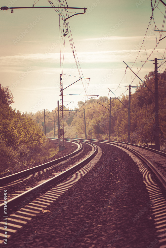 The train railway turns up left in summer landscape. Retro. Vintage.