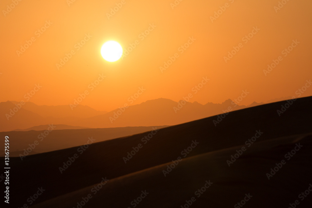 Hot sunrise in the desert dunes of Dubai, United Arab Emirates.